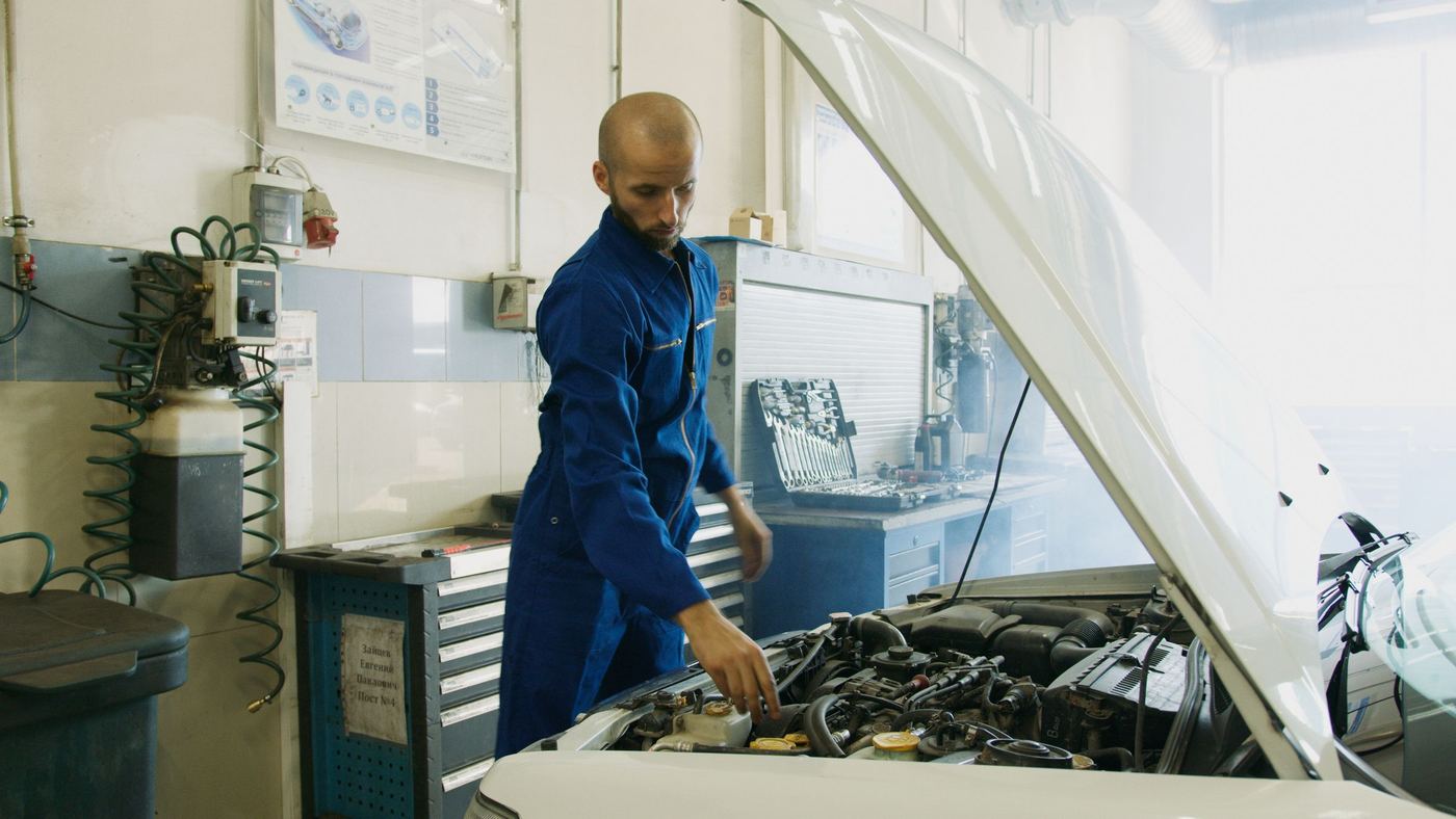 Technician checking an engine bay